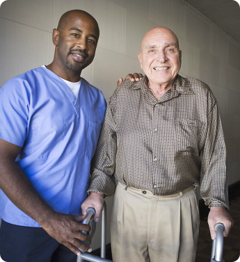 caregiver and senior man smiling